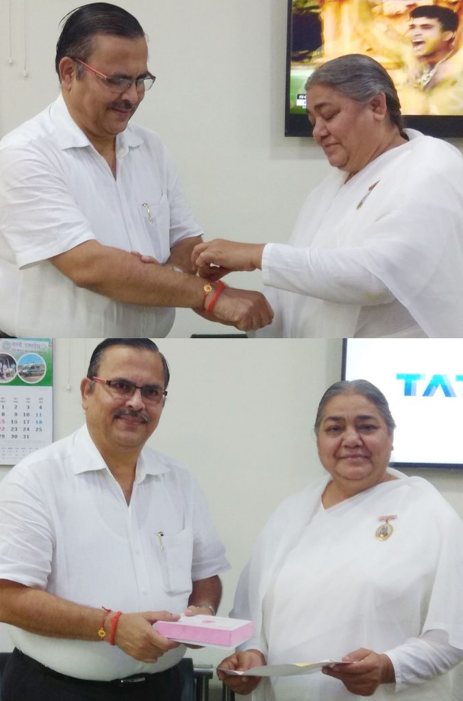 BK Shailja tying Godly Rakshasutra to DIG Anil Maheshwari.